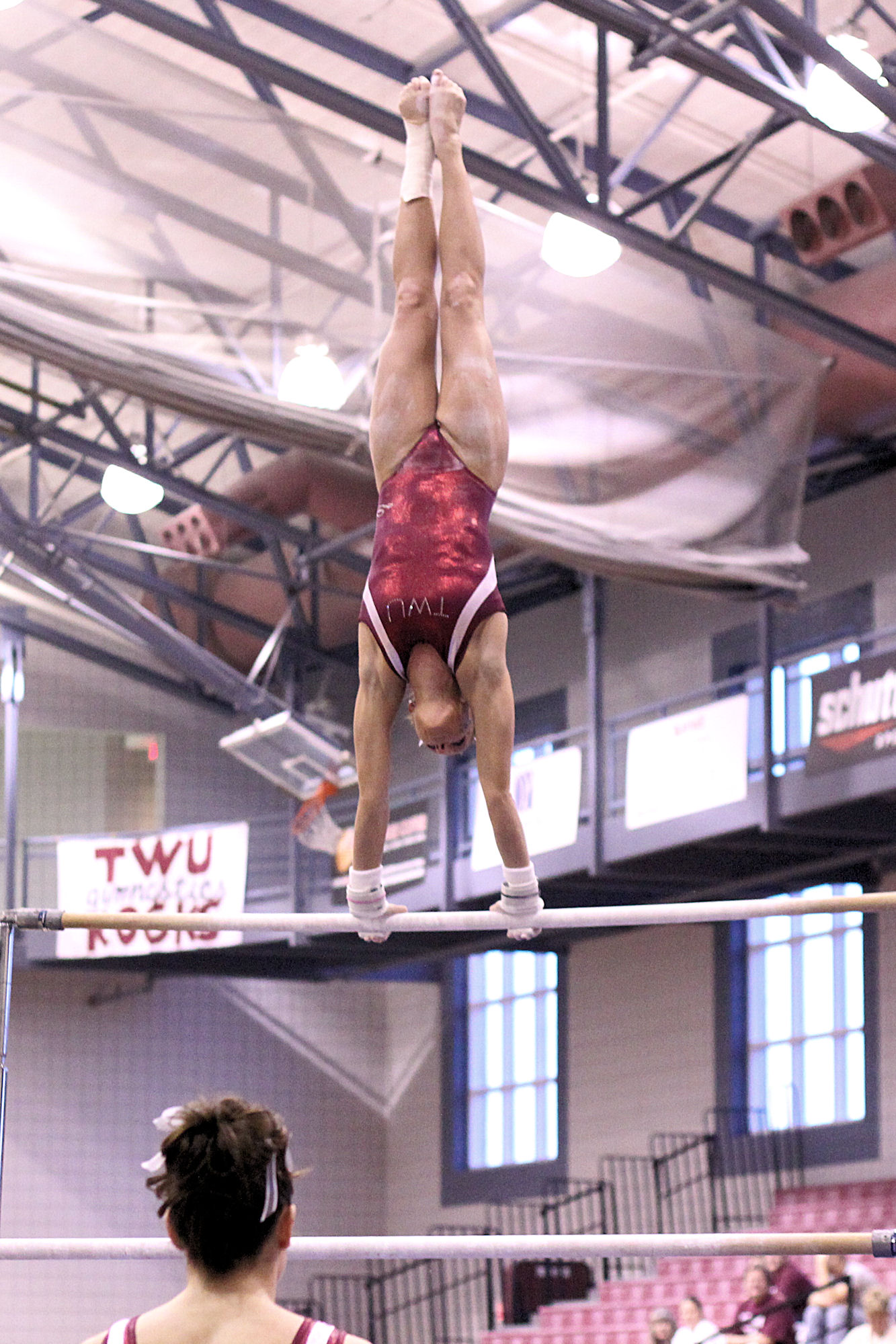 a person doing high jumps on parallel bars