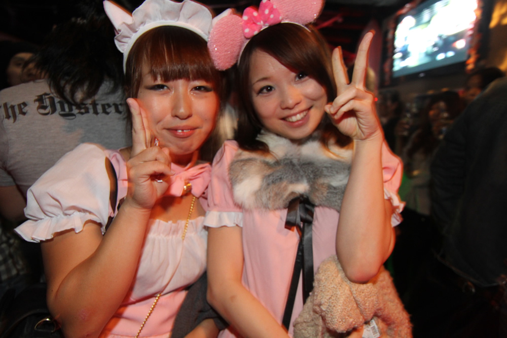a couple of girls with rabbit ears at a convention