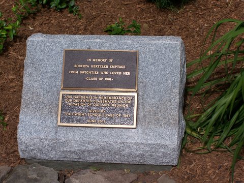 a memorial stone with a small plaque in it