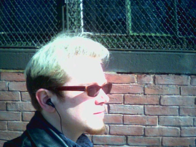 a person that is wearing a jacket and sunglasses