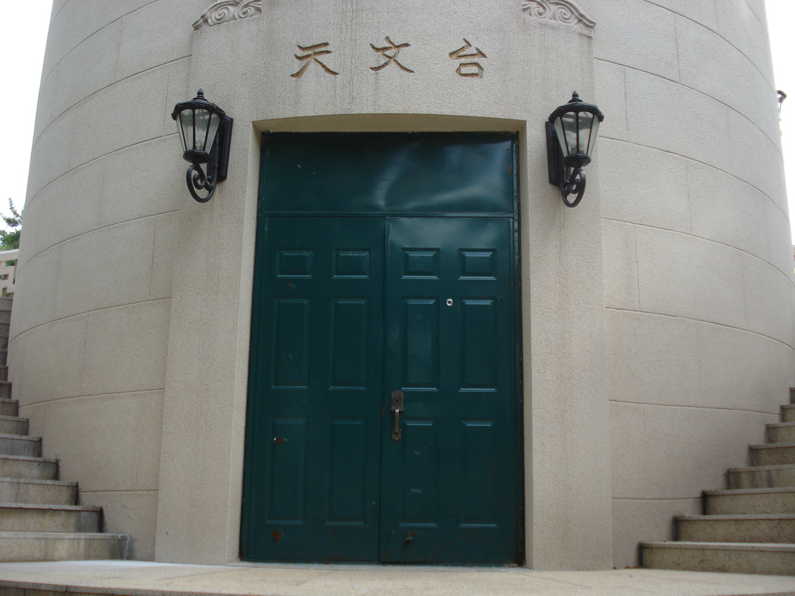 two light bulbs above the doors are on either side of a staircase