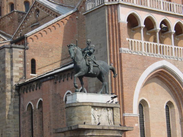 a statue of a person sitting on a horse outside