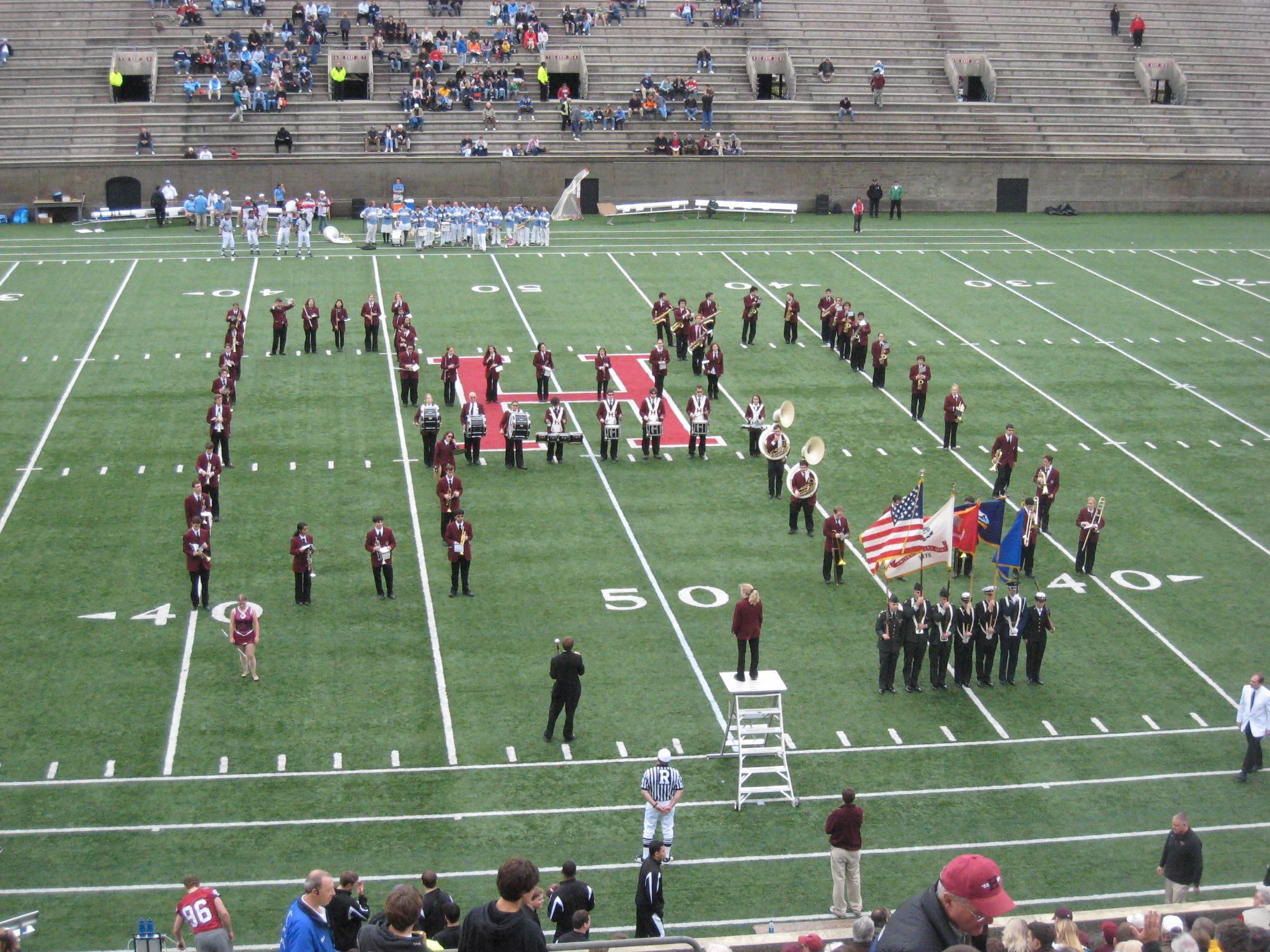 a band plays the football game in front of a football field