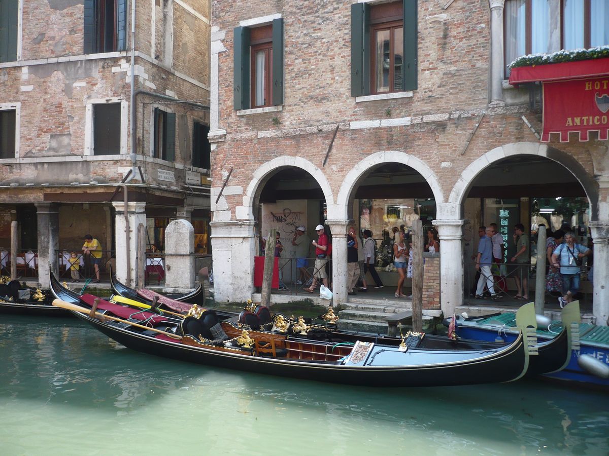 two gondolas sitting next to each other near an old building