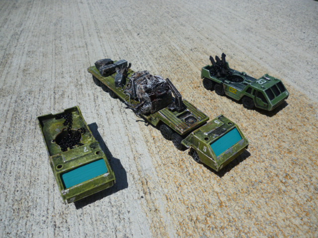 a couple of military vehicles on dirt ground