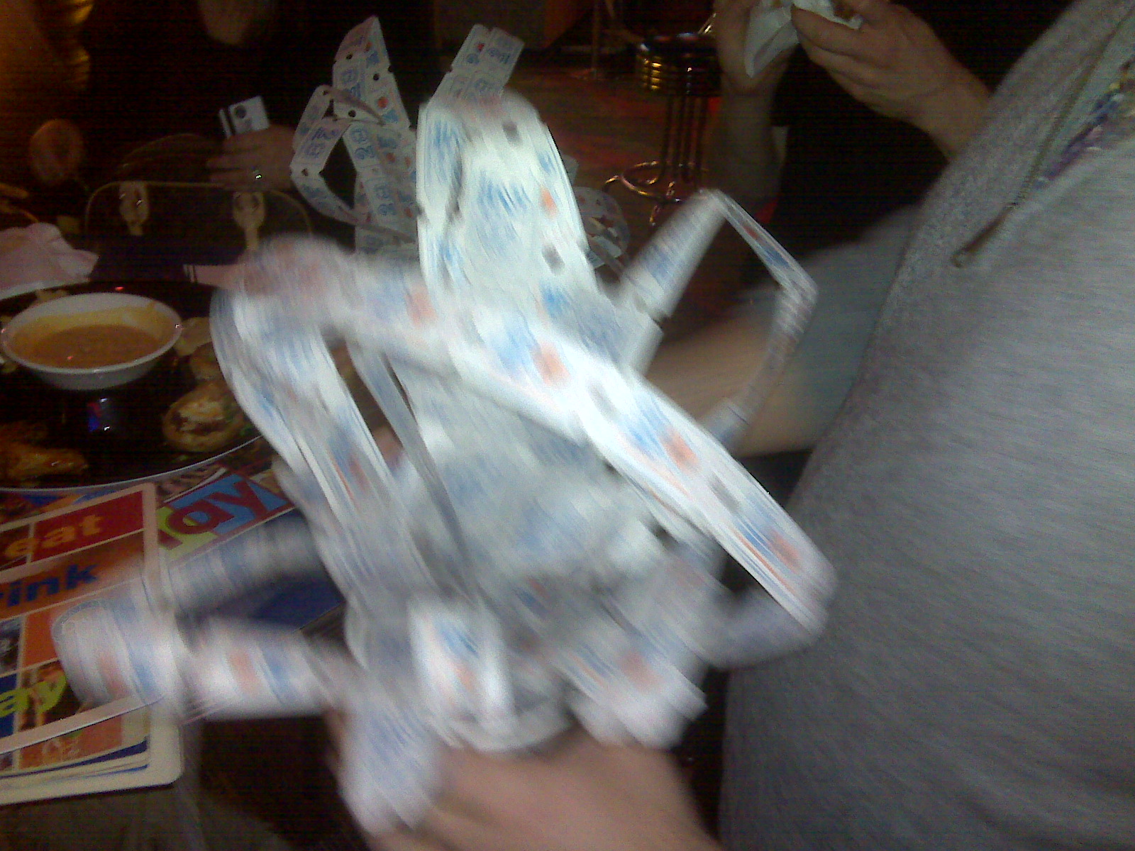 a woman holds up some clear plastic cups