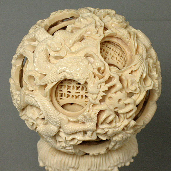 an elaborately carved white object on a stand