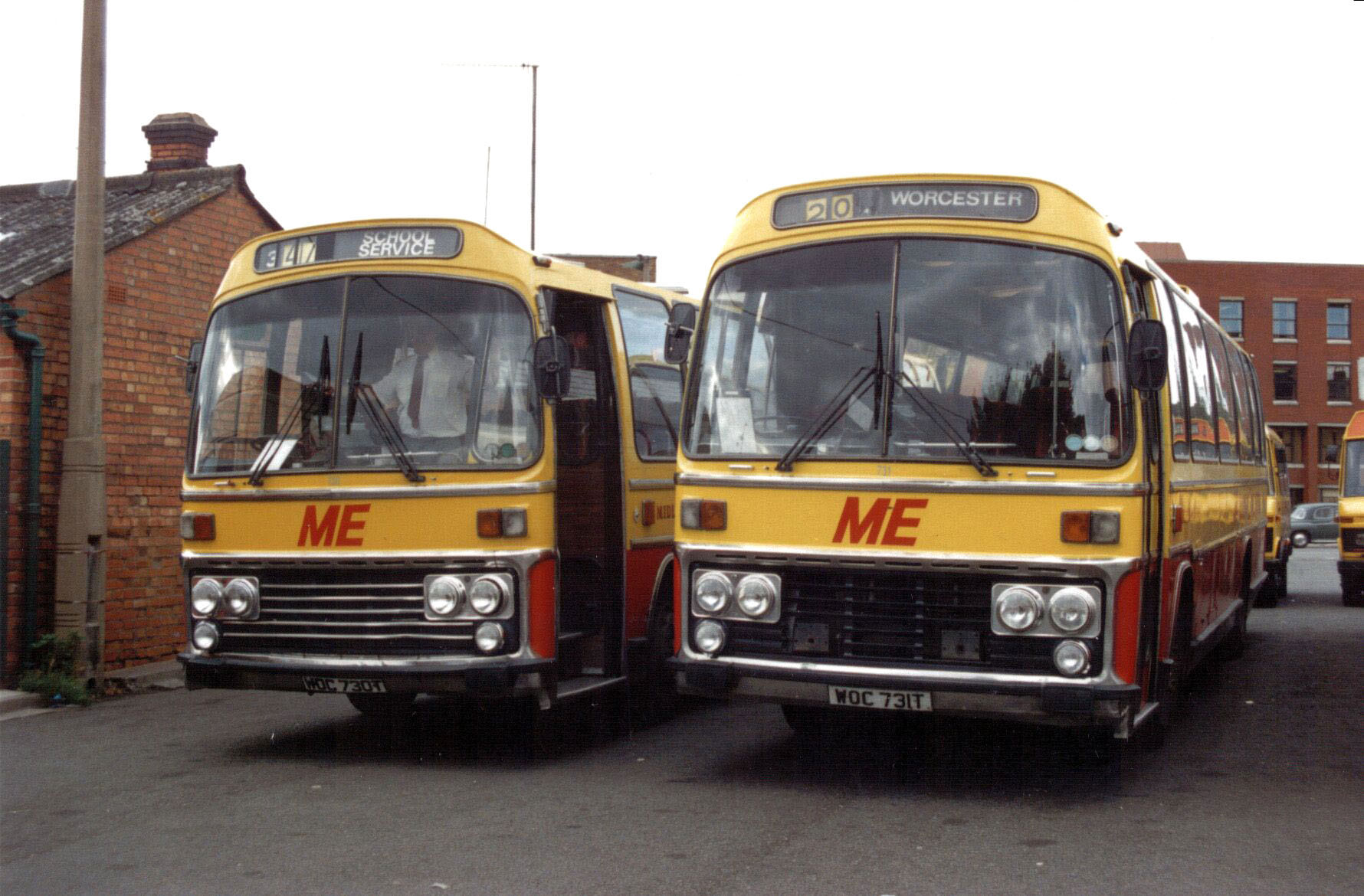 a couple of yellow busses sitting side by side