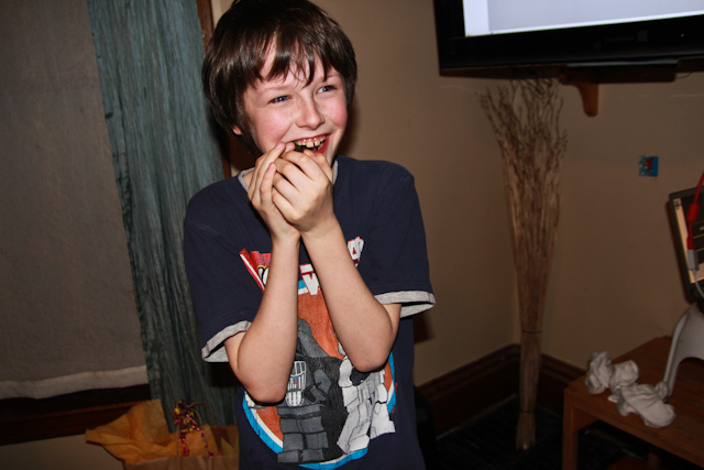a boy eating a doughnut while wearing his pajamas