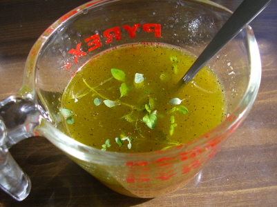 a glass cup with soup inside of it