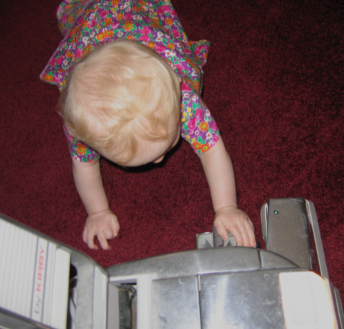 a small child reaching into an open keyboard
