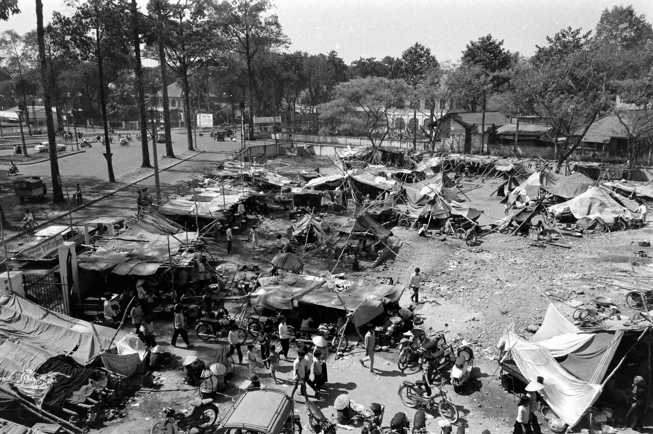 people gather around the camp site and many tents