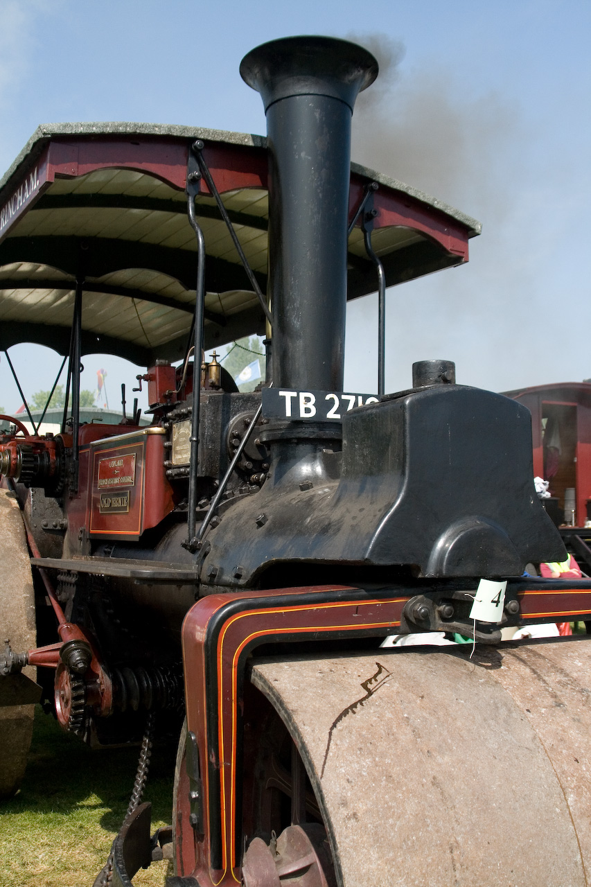 a tractor engine parked under a canopy