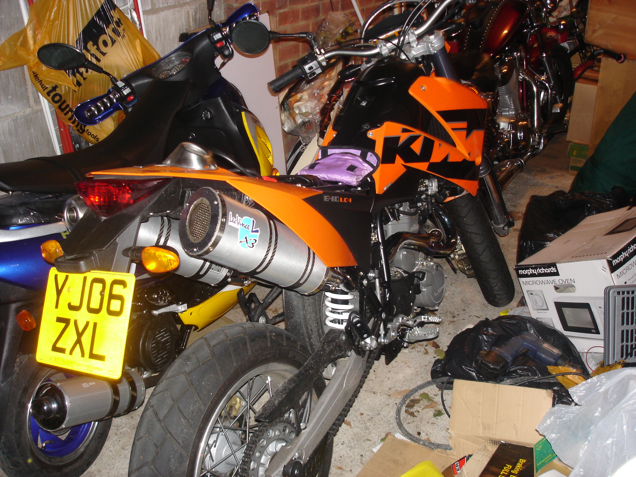 a close up of a motorcycle parked in a room with other bikes