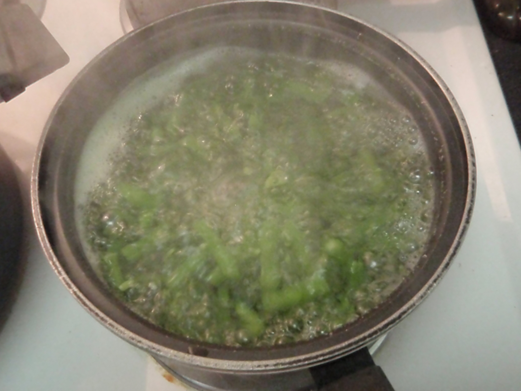 a pan filled with soup sitting on top of a stove