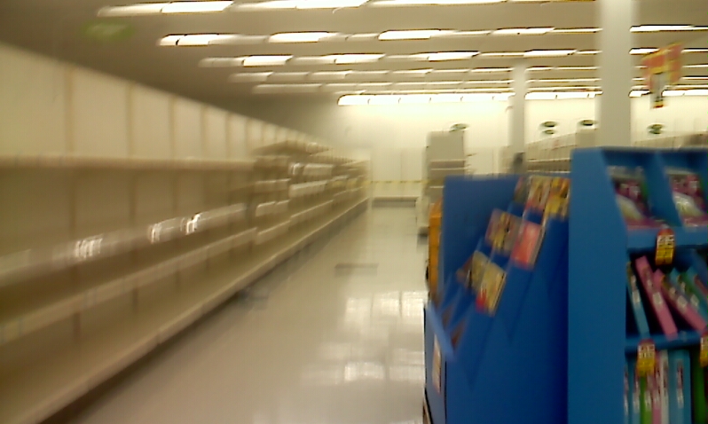 empty supermarket with shelfs and light from the top