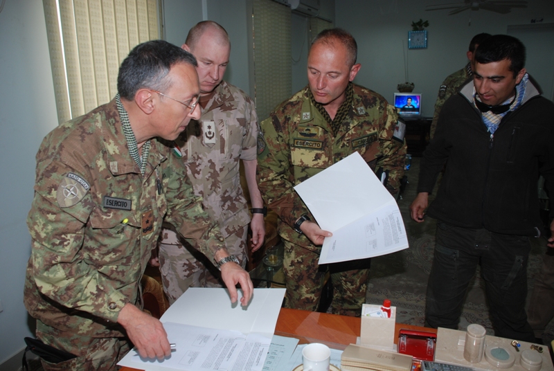 a group of soldiers gathered around papers and paperwork
