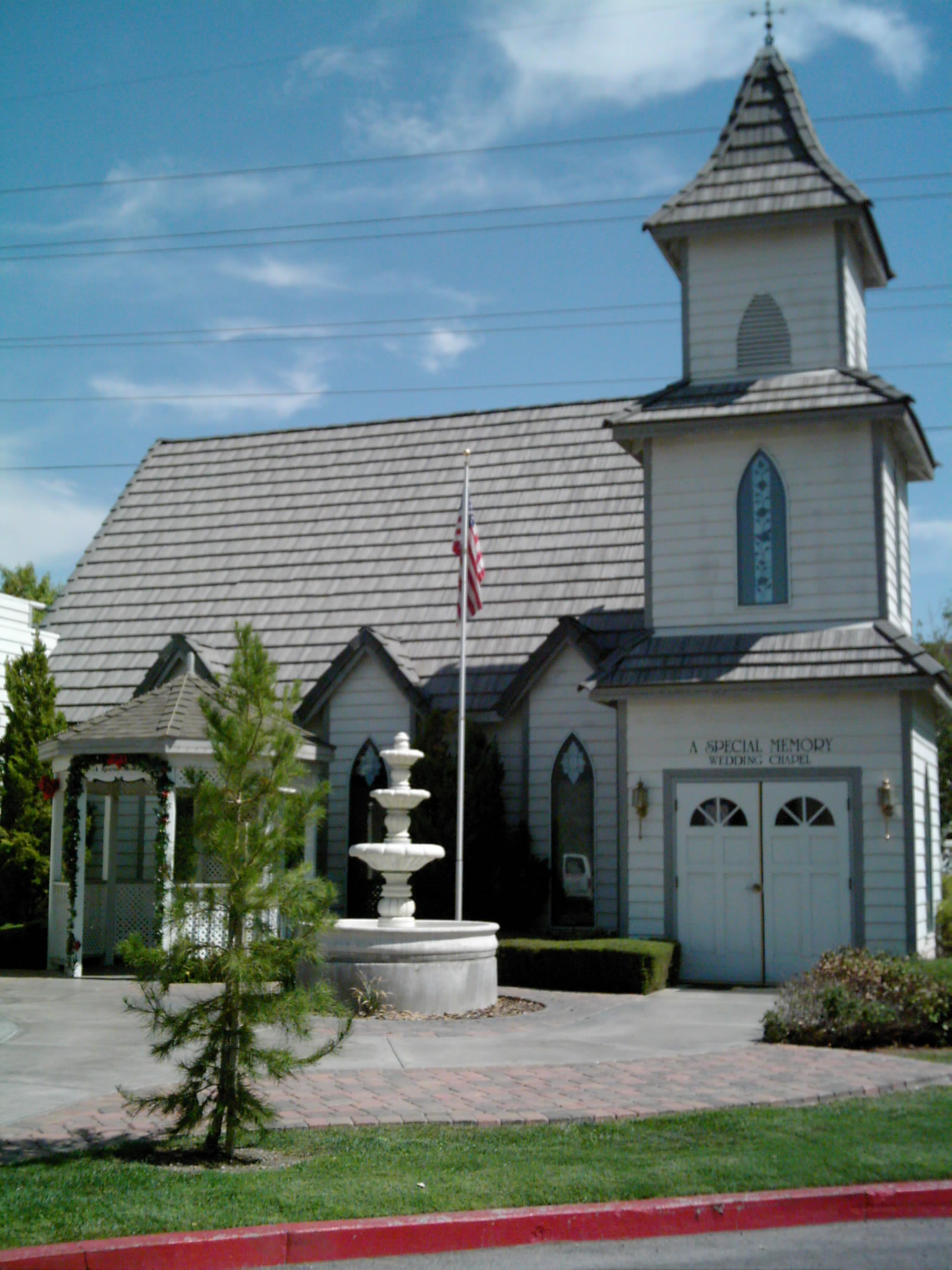 a large gray church with a fountain in front of it