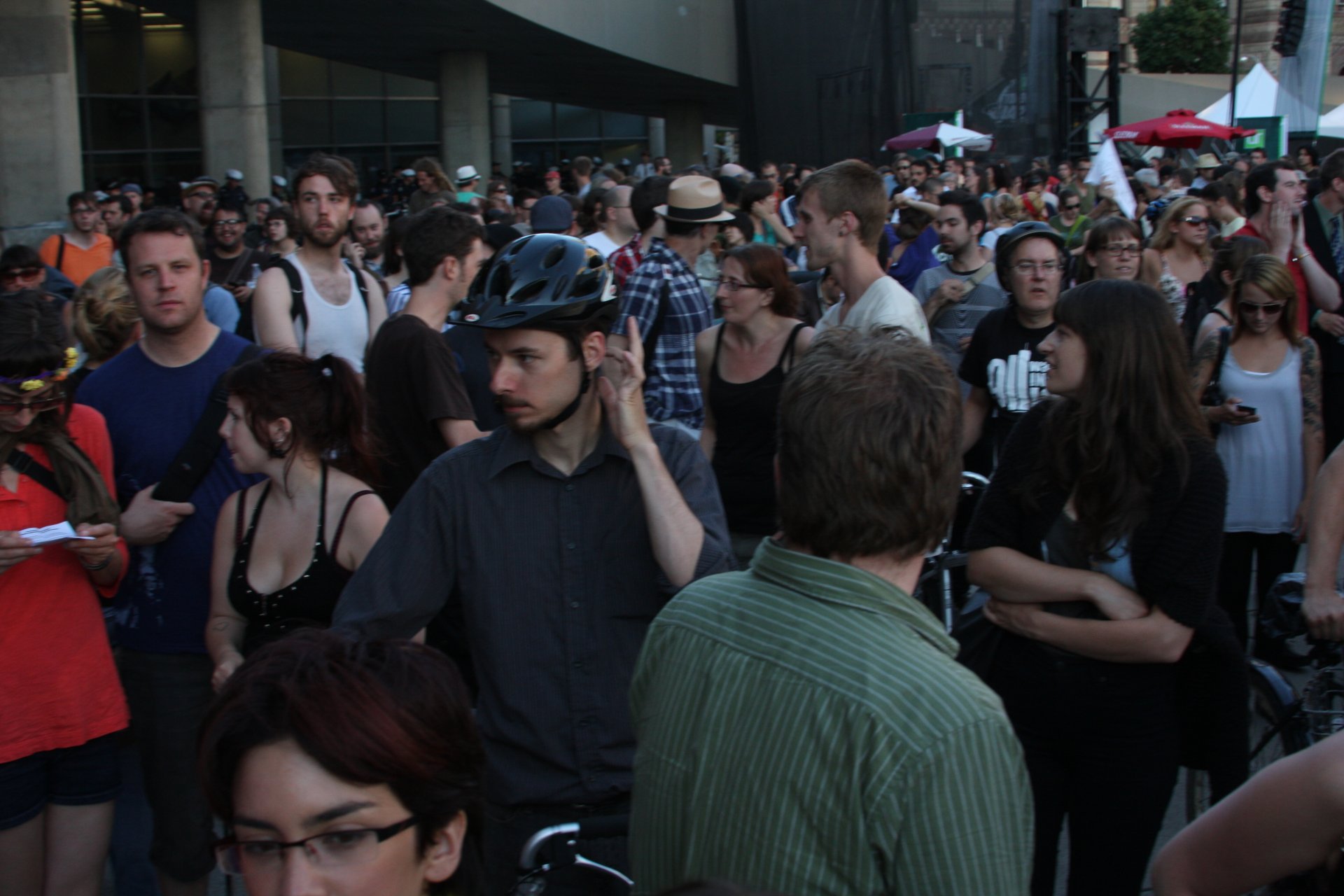 a large crowd of people walking around in the street