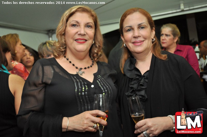 two women are dressed in black at a party