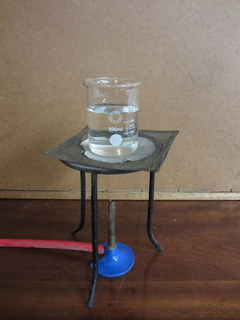 a water pitcher, hose and vase on a table