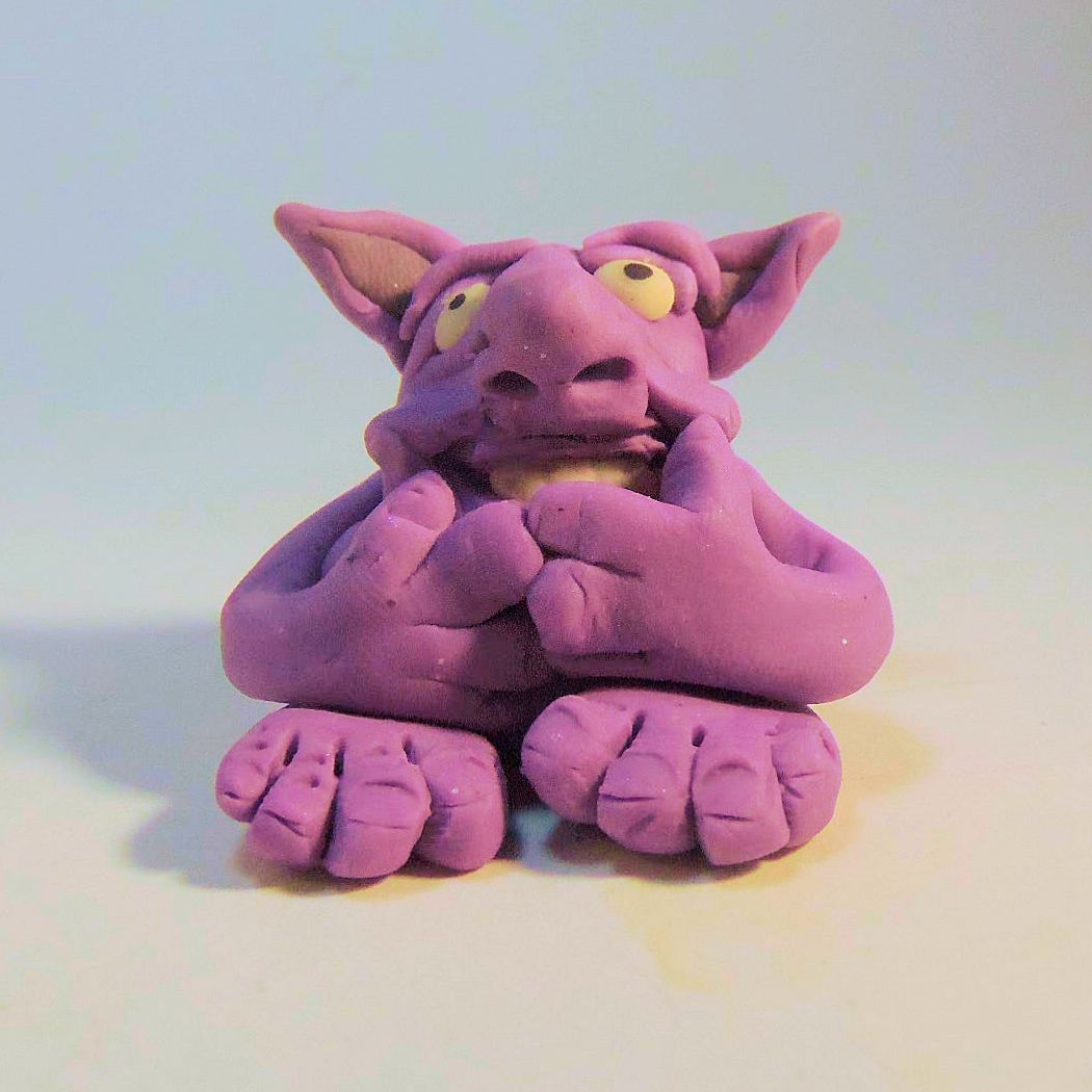 an image of a purple figure sitting on the ground