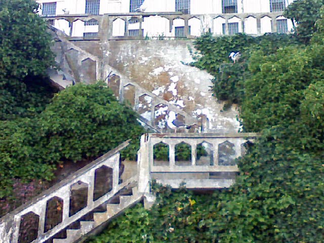 an abandoned staircase in front of a large building