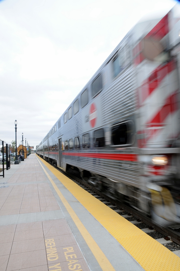 the train is traveling past the yellow crosswalk