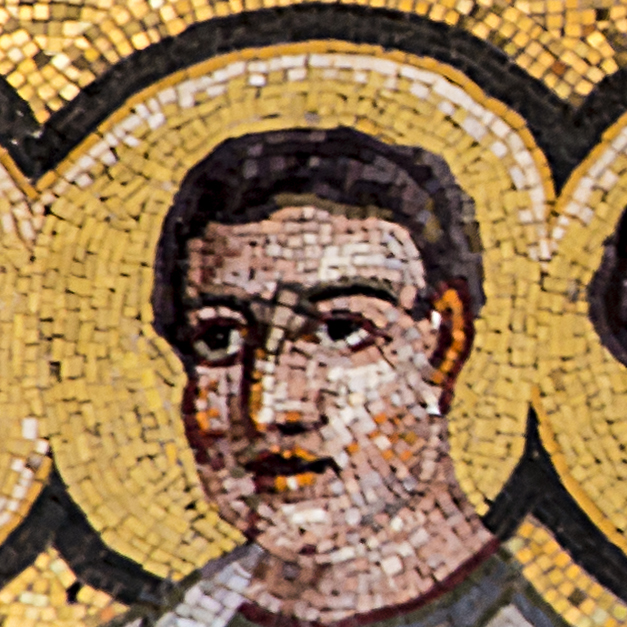 close up view of an mosaic with a man wearing a medal and other other gold items
