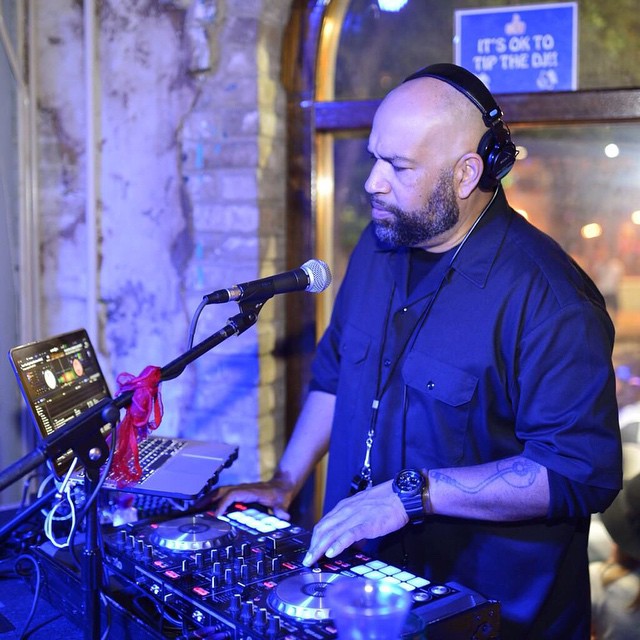 a man that is standing up playing dj equipment