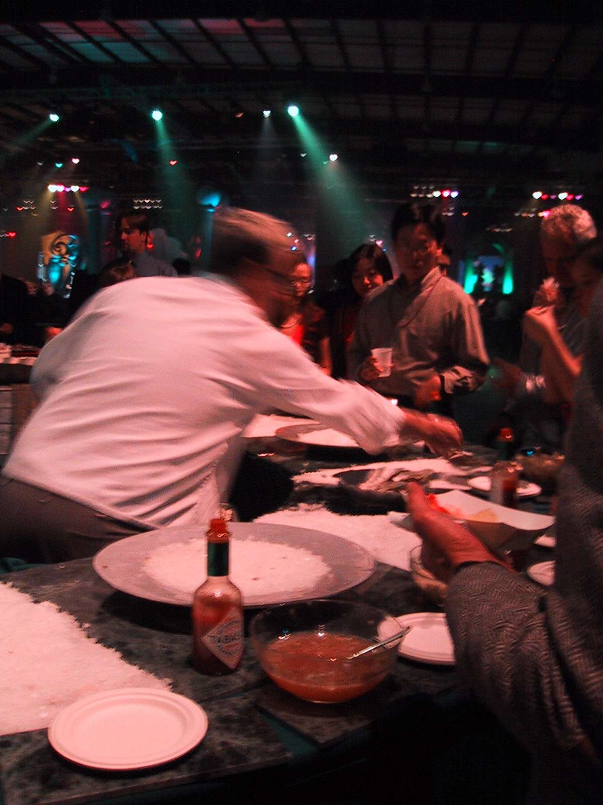 a group of people eating and talking at a party