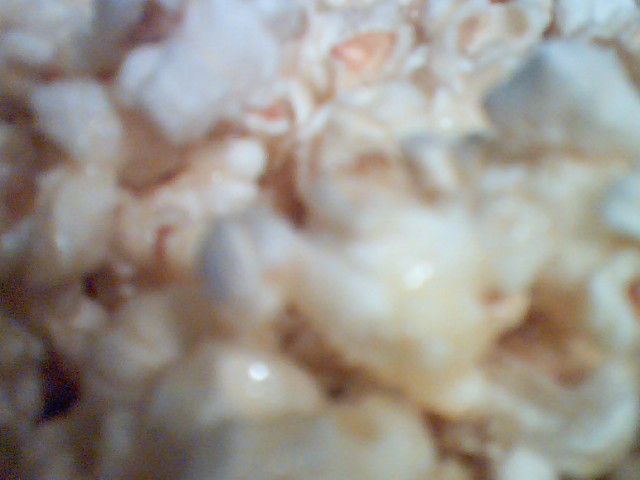 a pile of white and brown cereal that is partially eaten