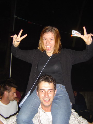 a woman sitting on top of a man at a concert