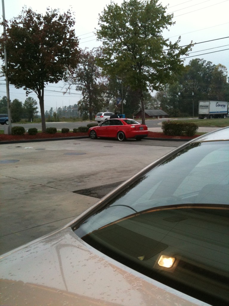 two cars parked in the parking lot outside a building