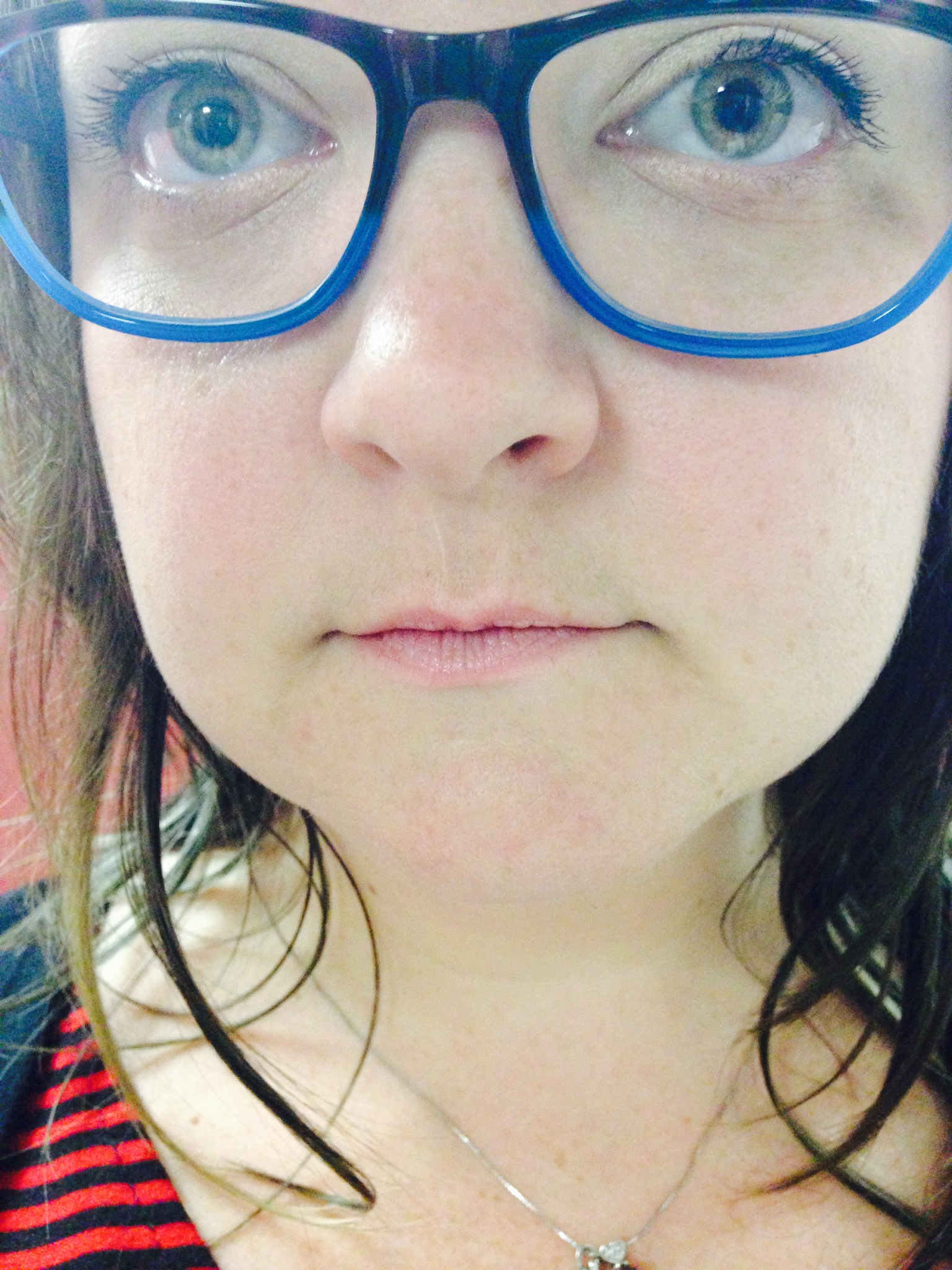 a close up of a woman with glasses and an umbrella