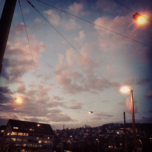 a street light with houses behind it on the side