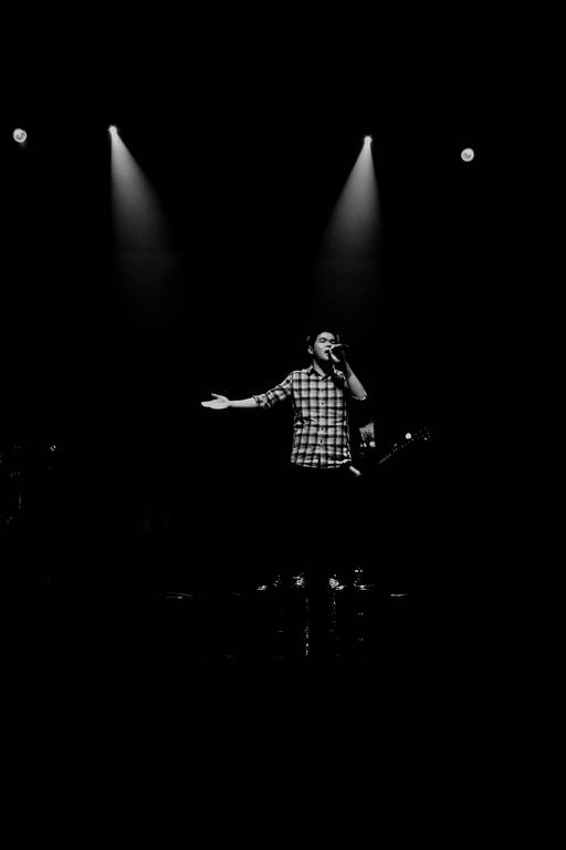 black and white po of a man singing into a microphone