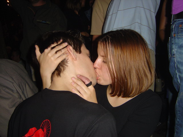 a girl kissing a guy at an event