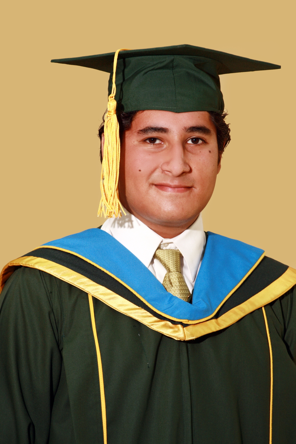 a man in a green graduation cap and gown