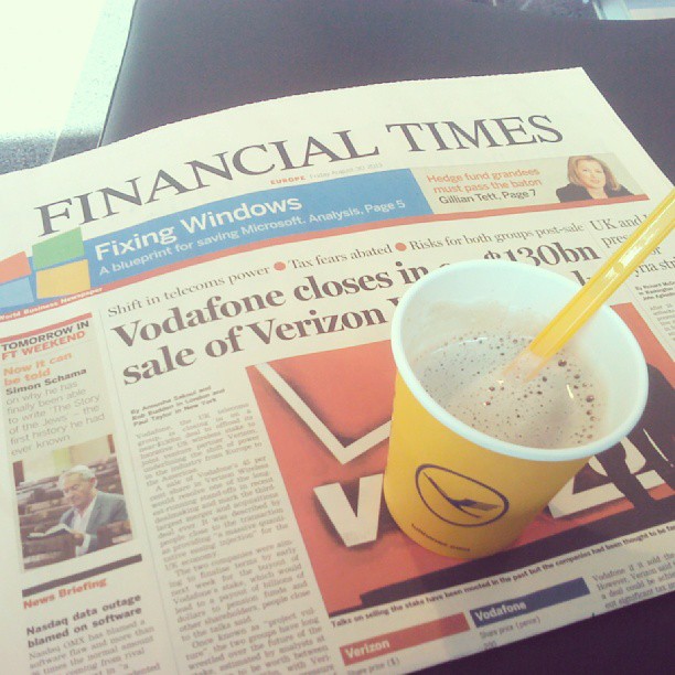 an article from the financial times newspaper features a cup of coffee with yellow straws in the bottom
