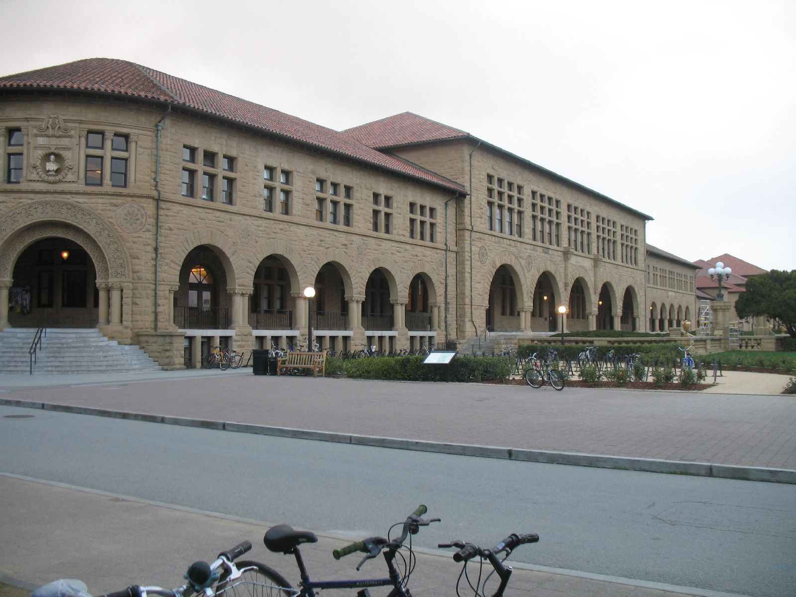 two bicycles parked in front of a large building