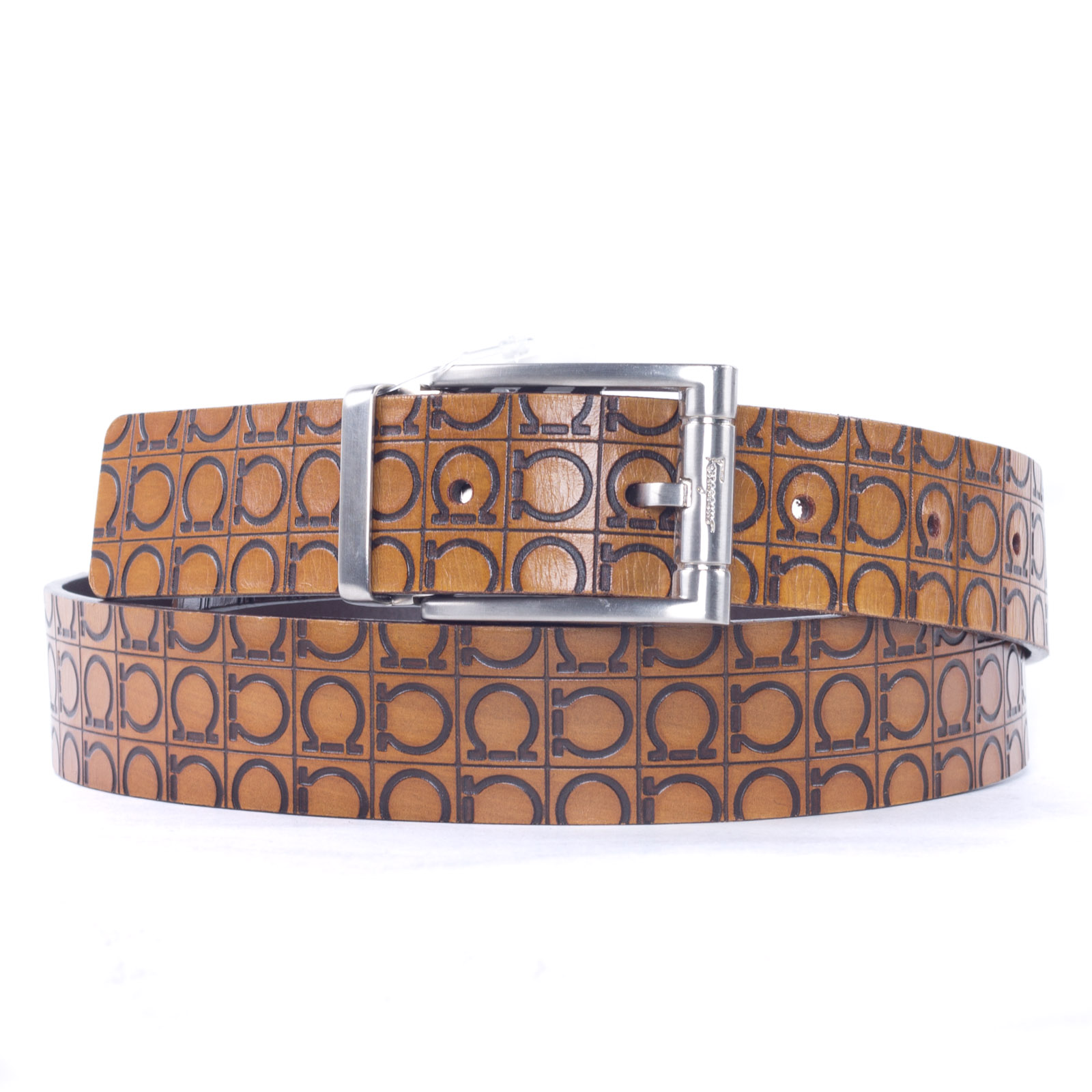 a tan leather belt with circles and silver buckle