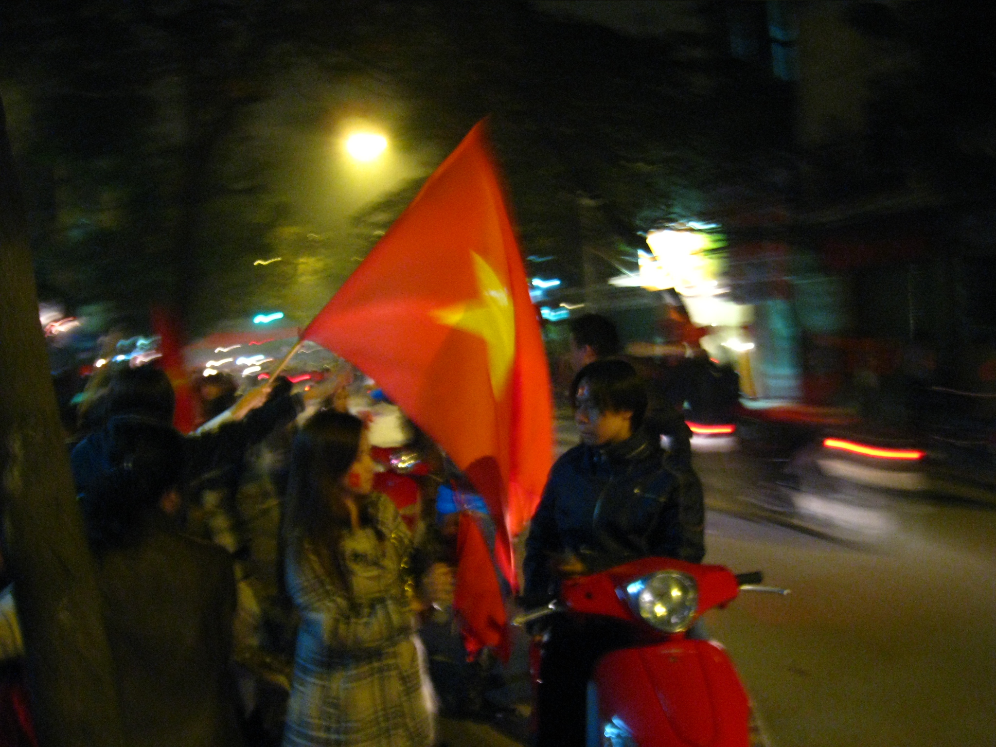 a crowd of people standing around on a street