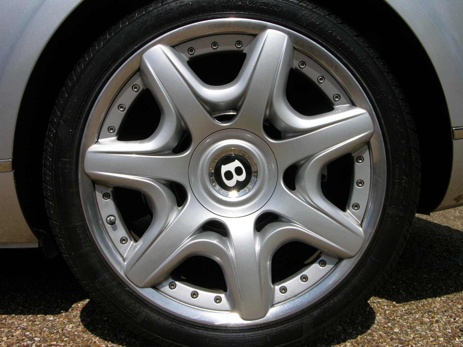 a silver car wheel with an image on the tire