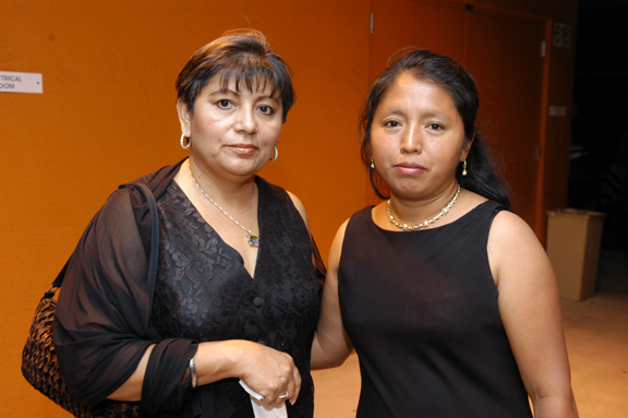 two woman in dress and pearls posing for the camera