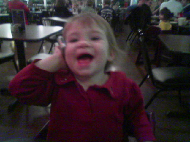 a child making faces while sitting at a table