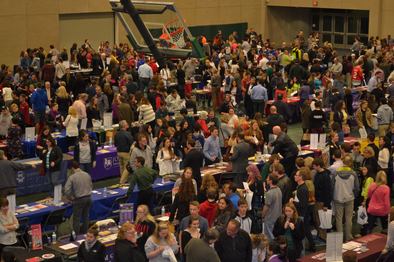 a large crowd of people standing around tables