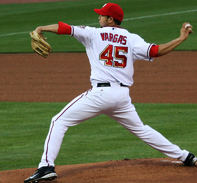 a baseball player pitching a ball during a game