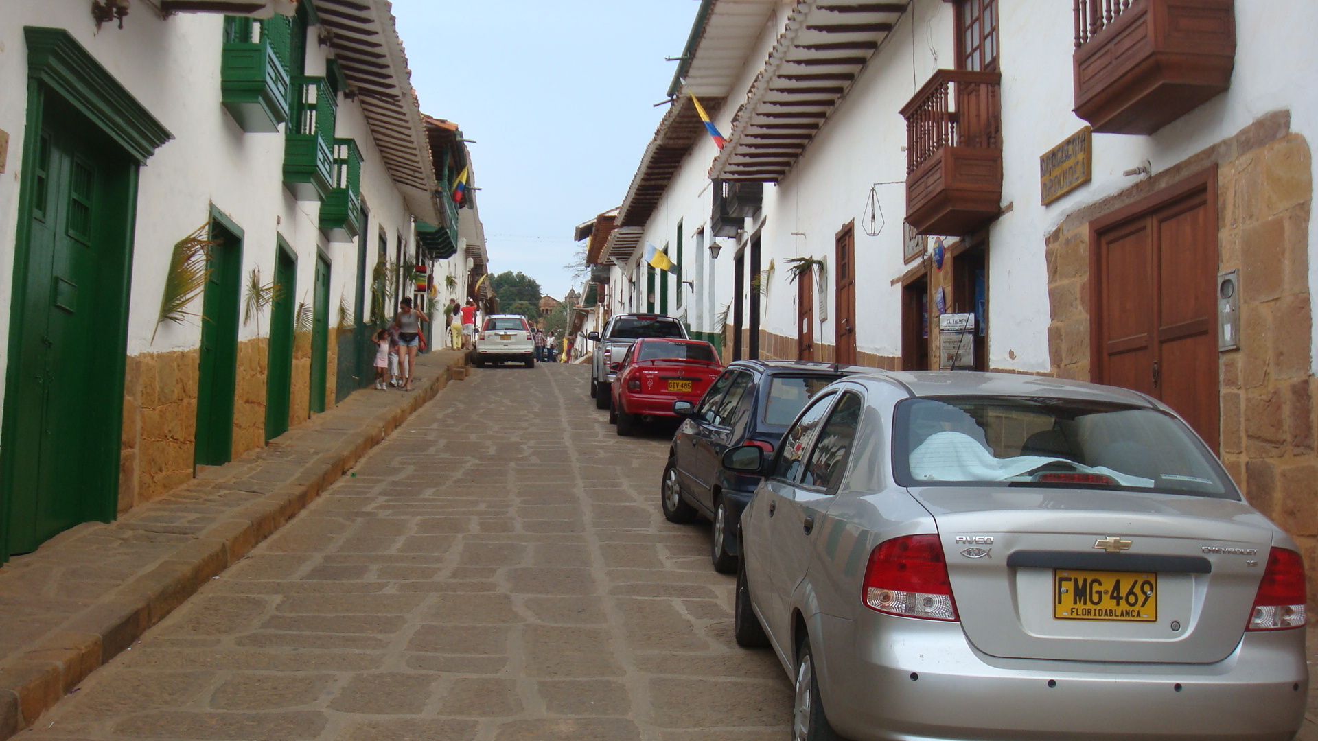 an image of some cars that are parked in front of a house