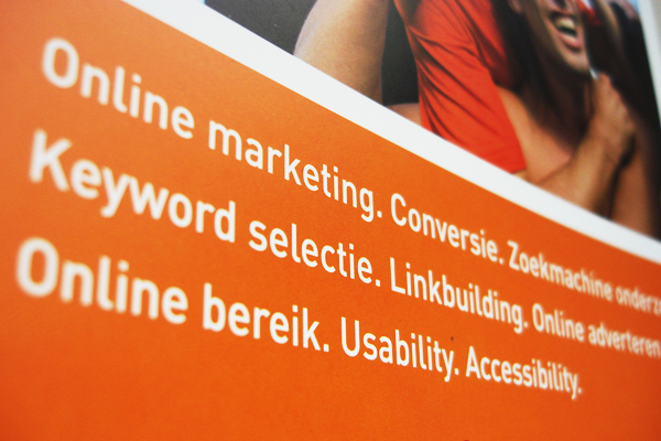 an orange advertising pamphlet with white words
